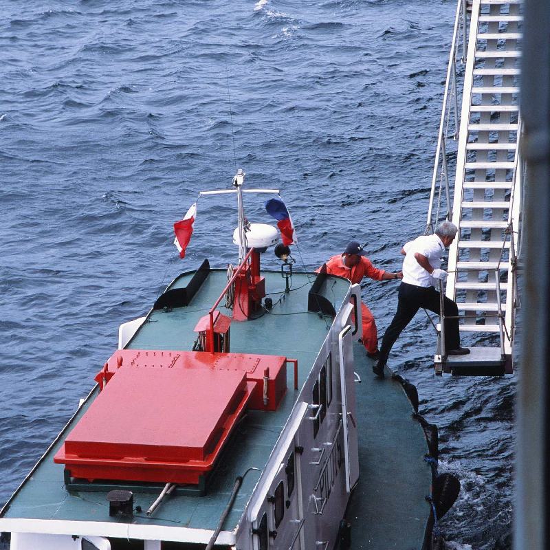 A pilot boards a container ship near Davao