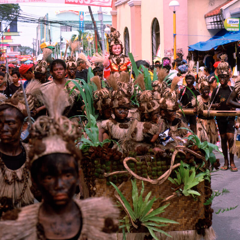 Ati-atihan, showing a procession honoring the "Santo Nino" or Blessed Child.